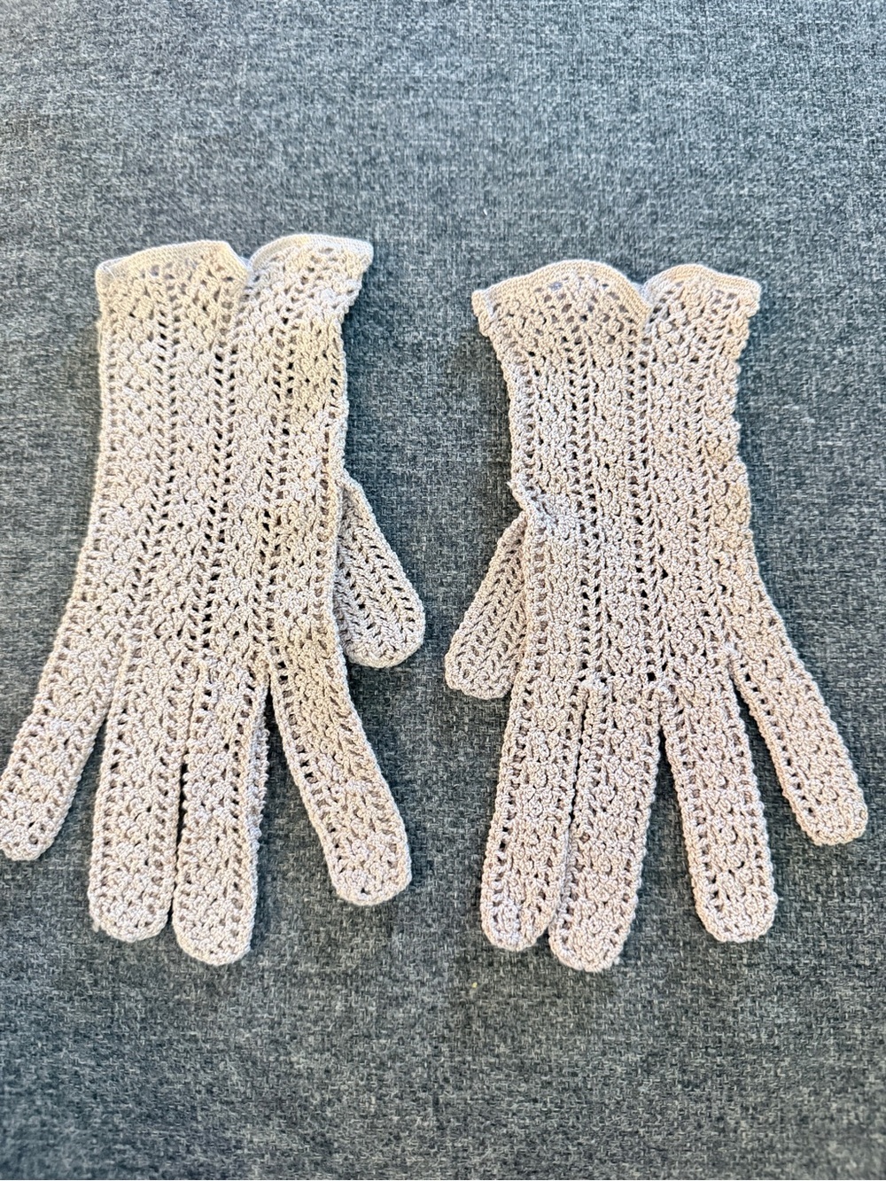 Vintage hand-crocheted soft pink short gloves with a delicate lace pattern